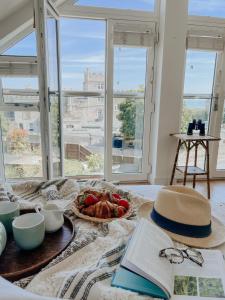 a table with a book and a plate of food at East Street Beach House - luxury living by the sea in Ryde