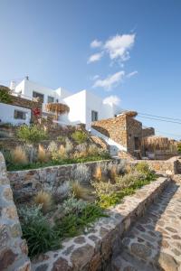 a stone staircase leading up to a house with white at The Summit of Mykonos in Kalo Livadi