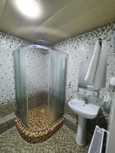 a bathroom with a shower and a sink at Reikartz Namangan in Namangan