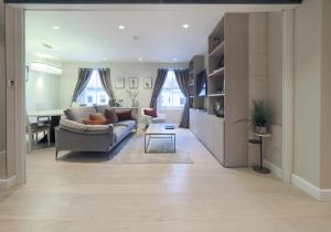 a living room with a couch and a table at Luxury 3 Bedroom Flat in Maida Vale in London