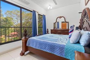 a bedroom with a bed and a balcony at Playa Negra Peaceful & Luxury Beach Dream Penthouse in Playa Negra