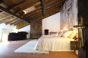 ein Schlafzimmer mit einem Bett und einem Sofa in einem Zimmer in der Unterkunft La Celeste Galeria in Mantua