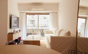 a living room with a white couch and a large window at Hestia At Patio Bullrich 1bdr Apartment in Buenos Aires
