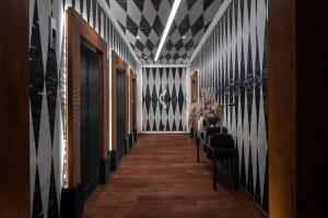 a hallway with black and white stripes on the walls at Hotel Fraye Nashville, Curio Collection By Hilton in Nashville
