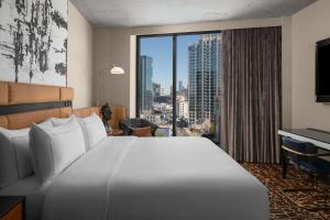 a hotel room with a large bed and a large window at Hotel Fraye Nashville, Curio Collection By Hilton in Nashville +54 photos