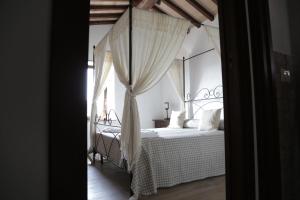 a bedroom with a bed with a canopy at Agriturismo Podere Acqualoreto in Acqualoreto