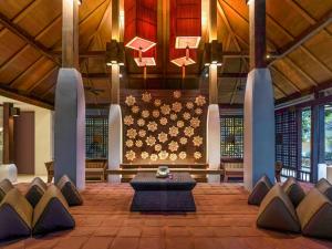a room with a table and chairs in a building at Pullman Phuket Karon Beach Resort in Karon Beach