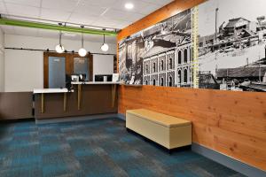 a waiting room with a bench in a building at CityFlatsHotel - Port Huron, Ascend Hotel Collection in Port Huron