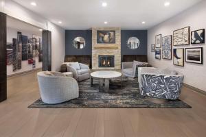 a living room with furniture and a fireplace at Country Inn & Suites by Radisson Asheville Downtown Tunnel Road in Asheville