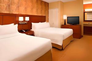 a hotel room with two beds and a television at Comfort Inn & Suites in Arlington Heights