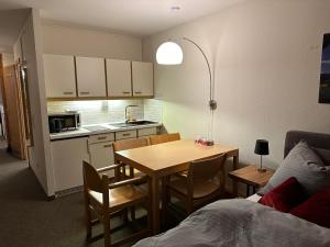 a small kitchen with a table and a dining room at Pleskini Apartments in Sankt Englmar