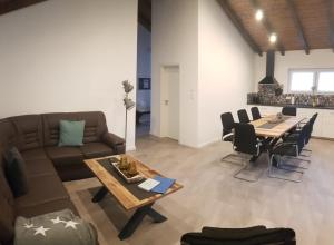 a living room with a couch and a table at Haus DeMa in Walkenried