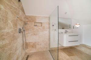 a bathroom with a shower and a sink at Yalicapkini Boutique Hotel in Gulluk
