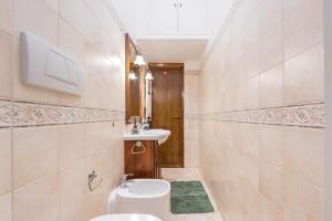 a bathroom with a toilet and a sink at Lungotevere Testaccio Apartment in Rome +15 photos