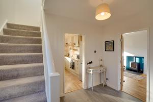 a stairway leading to a living room and a kitchen at The Birdhouse Family Home with Countryside Views in Beal
