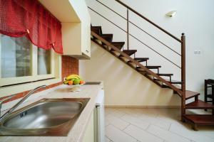 a kitchen with a sink and a staircase at Thassos Neorion in Limenaria