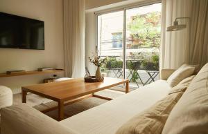 a living room with two beds and a table and a window at Hestia At Duhau 2bdr Near Patio Bullrich in Buenos Aires