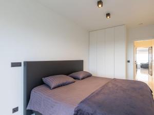 a bedroom with a large bed with two pillows on it at Luxury apartment with stunning sea views in Middelkerke