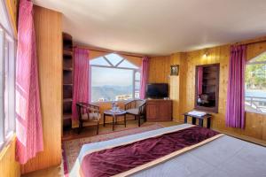 a bedroom with a bed and a large window at Agro Stone Cottage & Cafe in Mashobra