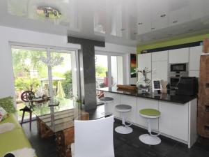 a kitchen with a counter and some stools in it at Holiday apartment La Maisonannette in Vinningen