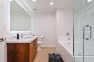 a bathroom with a sink and a toilet and a shower at Stylish & Cozy 2BDR & 2BTH in SM with Balcony for 6 pax in Los Angeles