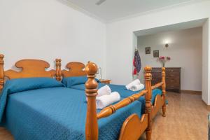 a bedroom with a blue bed with a wooden frame at Can Serra 4 -Santa Margalida- in Santa Margalida