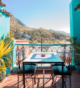 a table and chairs sitting on a balcony at Casa Sabila in Chefchaouen