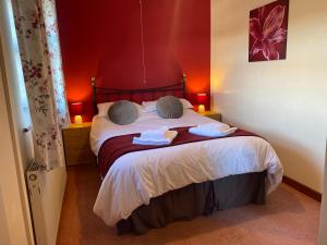 a bedroom with a bed with two towels on it at Captivating 5-Bed House with hottub near to Brecon in Brecon