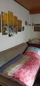 a bedroom with paintings on the wall and a bed at Ferienwohnung mit Terrassen für 1-4 Personen in Altena