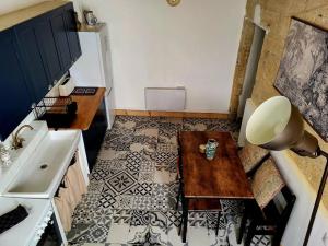 a small kitchen with a table and a sink at T2 Duplex "Chez Évelyne" in Remoulins