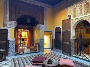 a living room with a couch and stained glass windows at Ryad El Borj in Marrakech