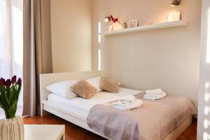 a bedroom with a bed with towels on it at Apartamenty Przemyśl in Przemyśl