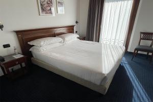 Postel nebo postele na pokoji v ubytování Hotel Villa Dei Carpini