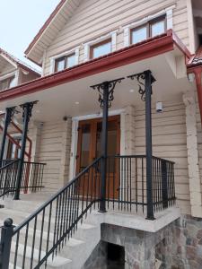 a front porch of a house with black railing at S Neries 19 apartamentai su parkingu in Šiauliai +53 photos