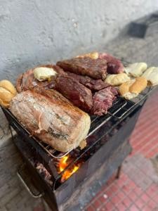 a bunch of meat and other foods on a grill at I Love Rio Hostel in Rio de Janeiro