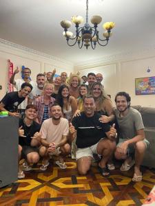 a group of people posing for a picture in a room at I Love Rio Hostel in Rio de Janeiro