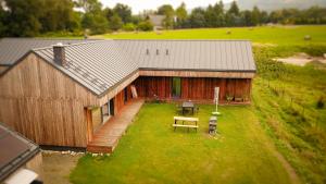 an overhead view of a barn with a table and benches at Stodoła in Ściegny