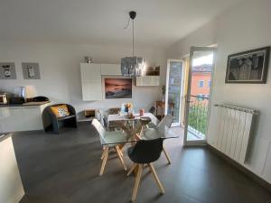 a kitchen and living room with a table and chairs at Penthouse Federico with lake view - Residenza Silvana in Verbania
