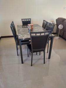 a dining room table with four chairs and a table and chairsktop at Remarkable 2-Bed House in Old Harbour in Old Harbour