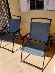 two chairs sitting next to each other in a room at Remarkable 2-Bed House in Old Harbour in Old Harbour