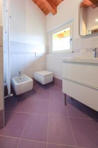 a white bathroom with a sink and a toilet at Penthouse Federico with lake view - Residenza Silvana in Verbania +31 photos