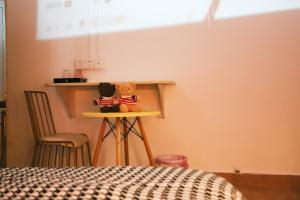 two teddy bears sitting on a table in a room at Changsha Fuxiangyuan International Hostel in Changsha