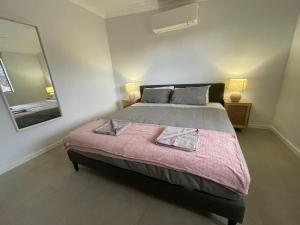 a bedroom with a large bed and a mirror at Carpenter House in Exmouth
