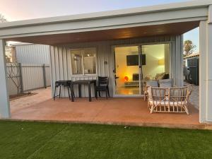 a screened in patio with a table and chairs at Carpenter House in Exmouth