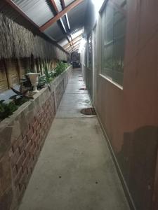 an empty hallway of a building with plants at HospedajesPerú in Zorritos