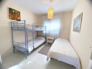 a bedroom with two bunk beds and a bed at Angeles 9 in Roses