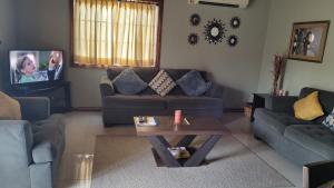 a living room with a couch and a coffee table at 12 Fairway Avenue in Kingston