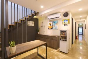 a room with a staircase and a table in a house at Lukang Barn Inn in Lugang