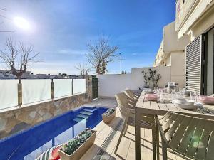 eine Terrasse mit Tisch und Stühlen auf einem Balkon in der Unterkunft Los Alcazares Villa - 3010 in Los Alcázares