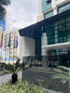 a sign in front of a building with flags at Blue Tree Premium Paulista in Sao Paulo